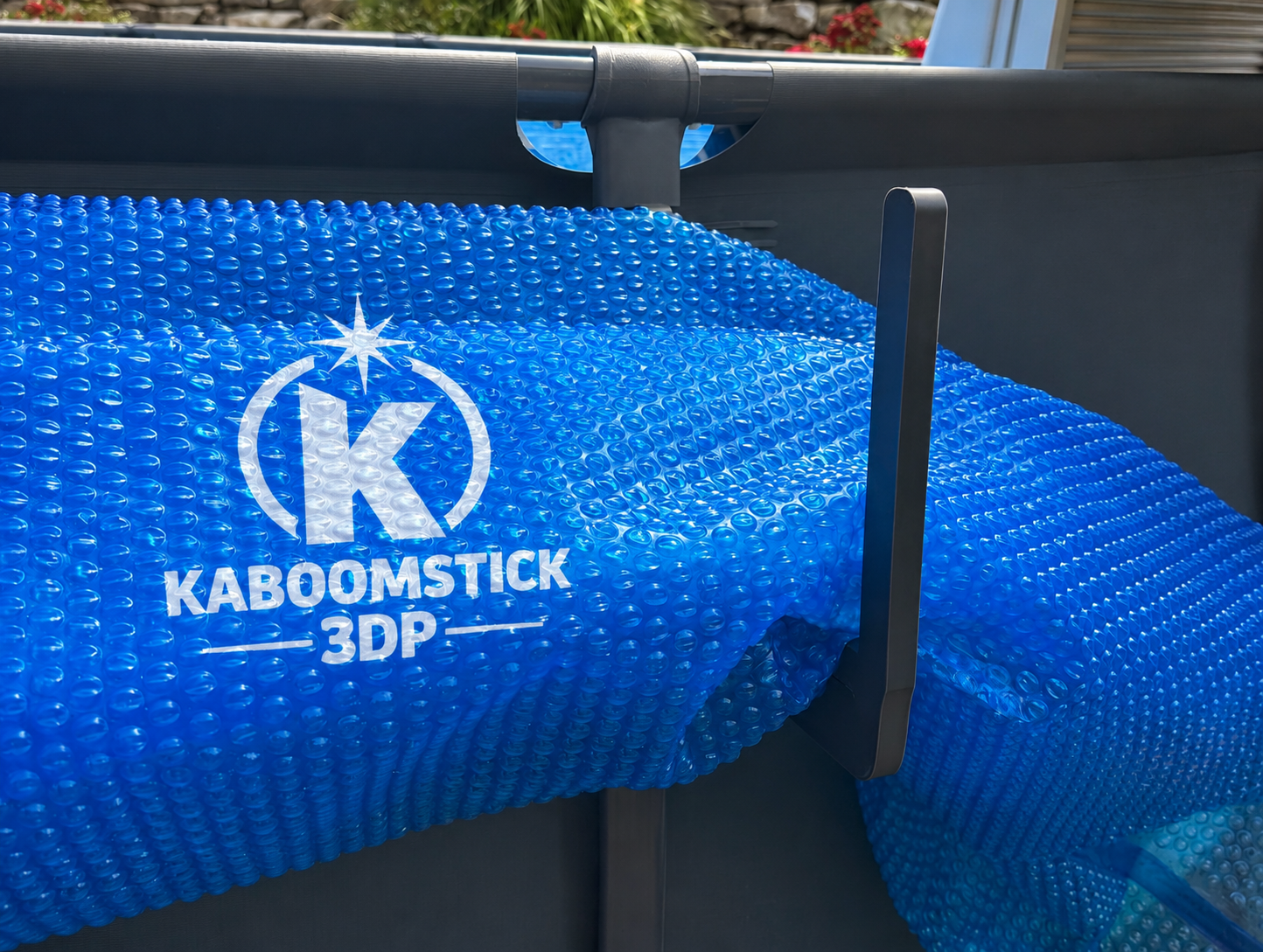 Solar Hook XL supporting a large rolled solar cover on an above-ground pool. Rust-proof premium ABS construction for Intex, Coleman, and Bestway pools.