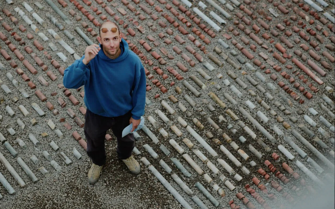Artist Carlos Irijalba stands in the center of his art installation looking up