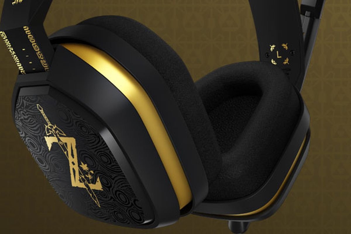 Close-up of a black and gold gaming headset with decorative black and gold ear cups and a padded headband.