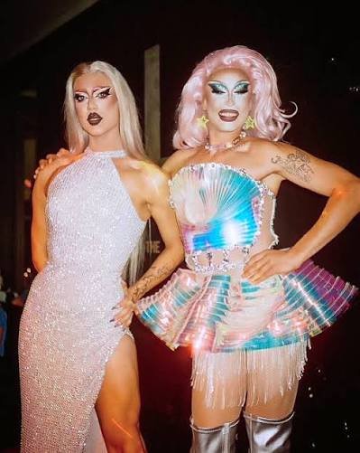 image of two drag performers with costumes and make up on