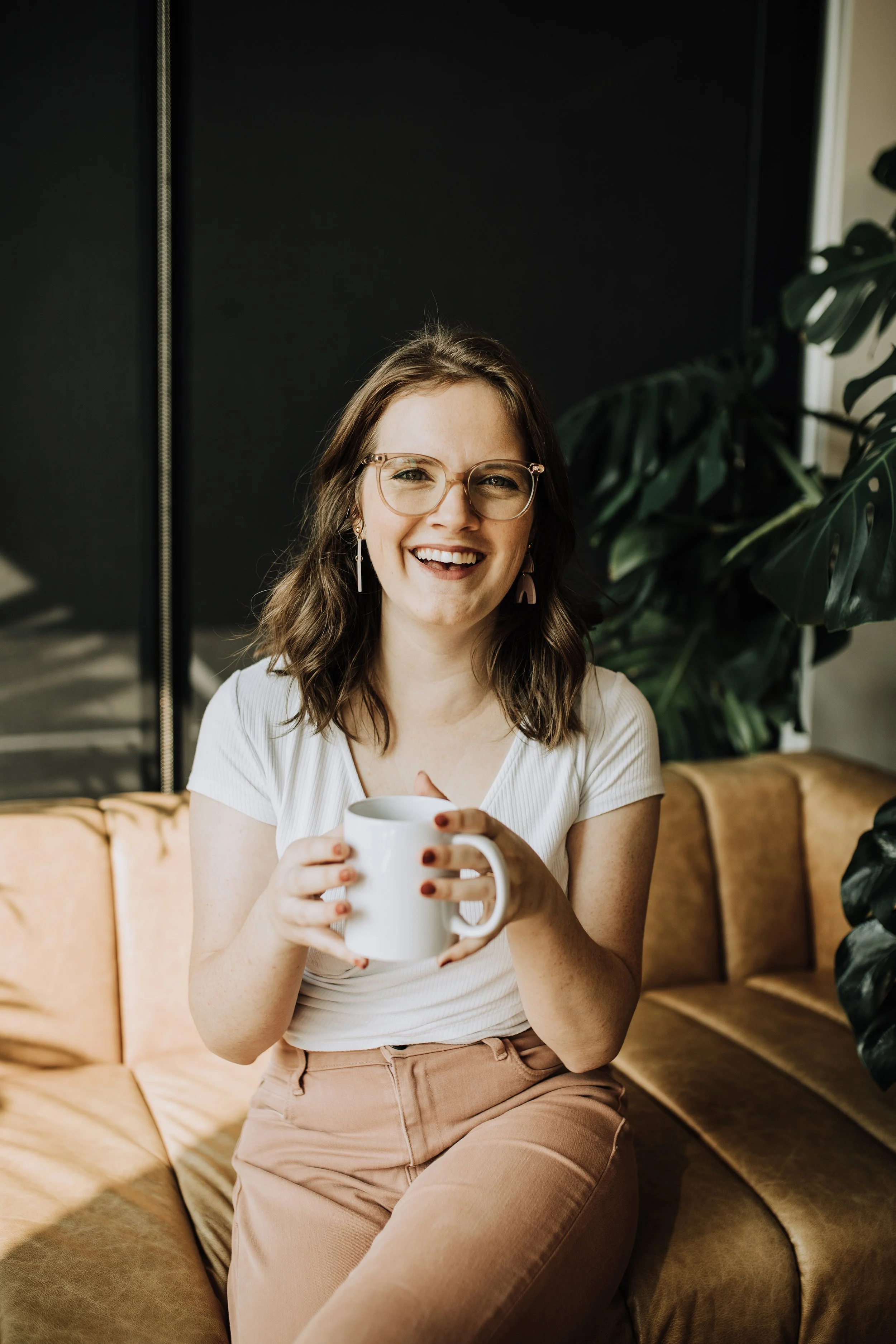 image of a young woman sitting on a couch holding a coffee mug