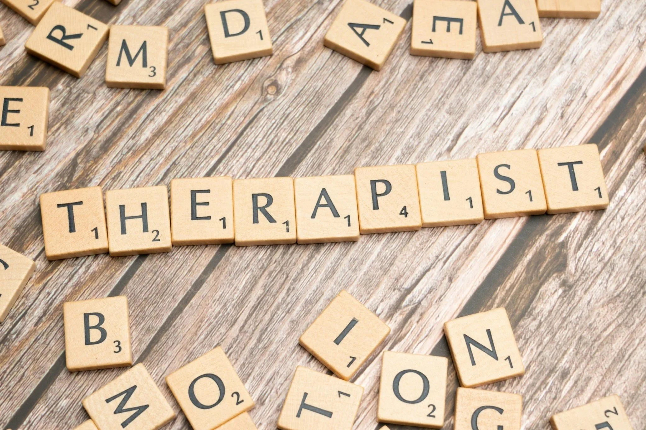 photograph of scrabble tiles spelling out the word "therapist" for online therapy with Sarah Schufreider, LCSW