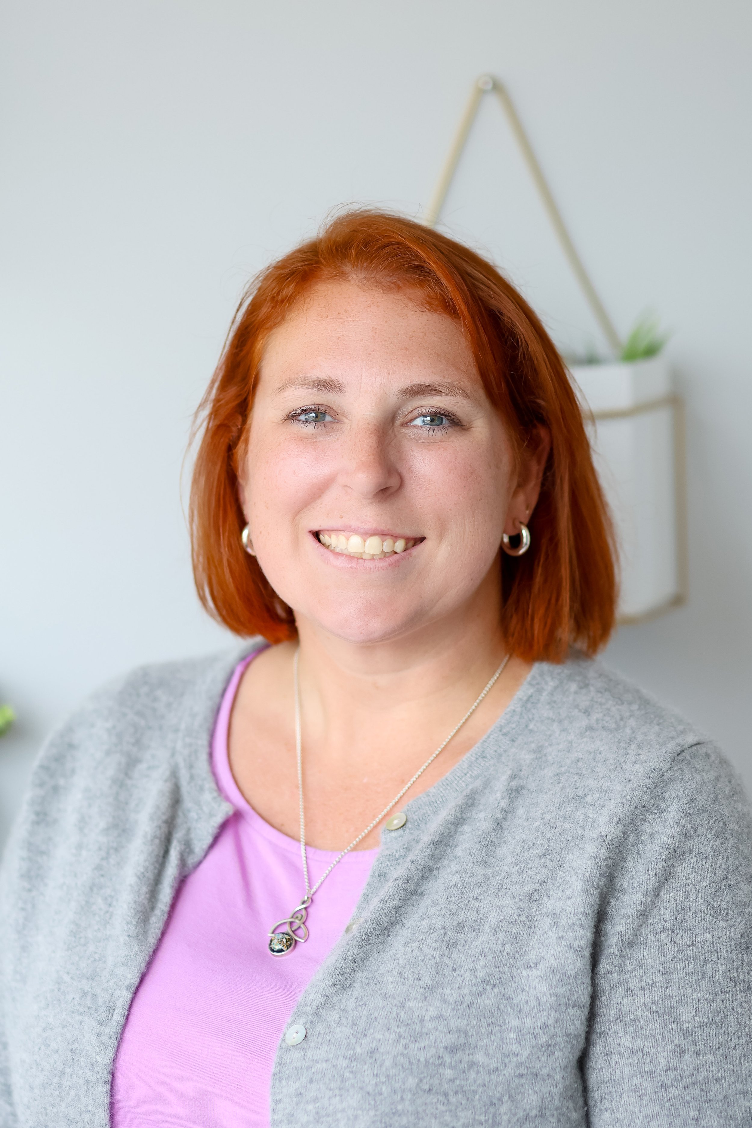 Sarah Schufreider, LCSW, smiling in a grey cardigan — SPACE-trained parent coach for childhood anxiety in Chicago, Illinois