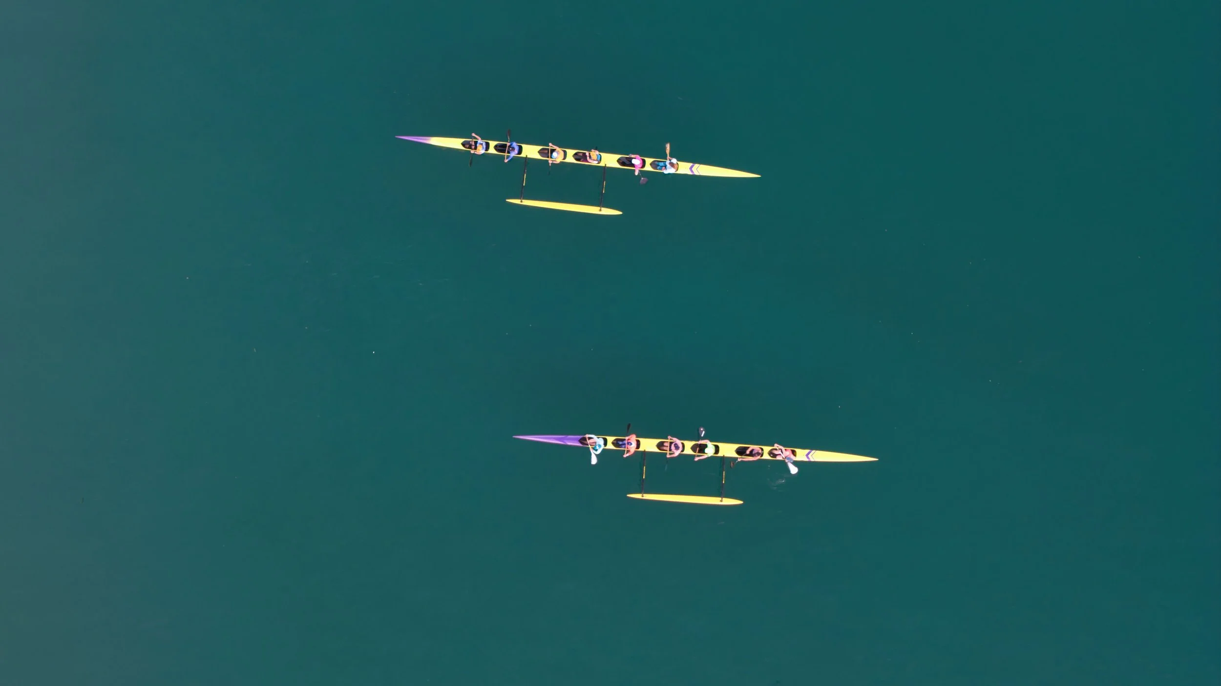 Overhead shot of Pale Kai Outrigger canoes on teal water in Avila Beach