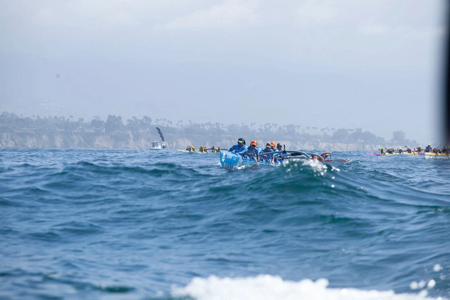 Group of rowers competing in a rowing race on the ocean.