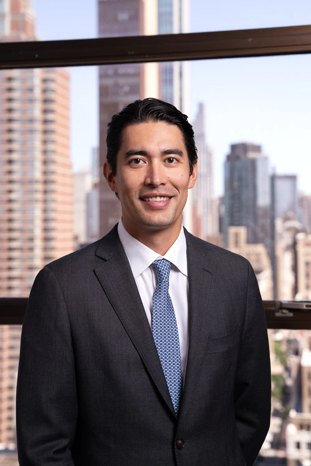headshot of attorney with city skyline in manhattan