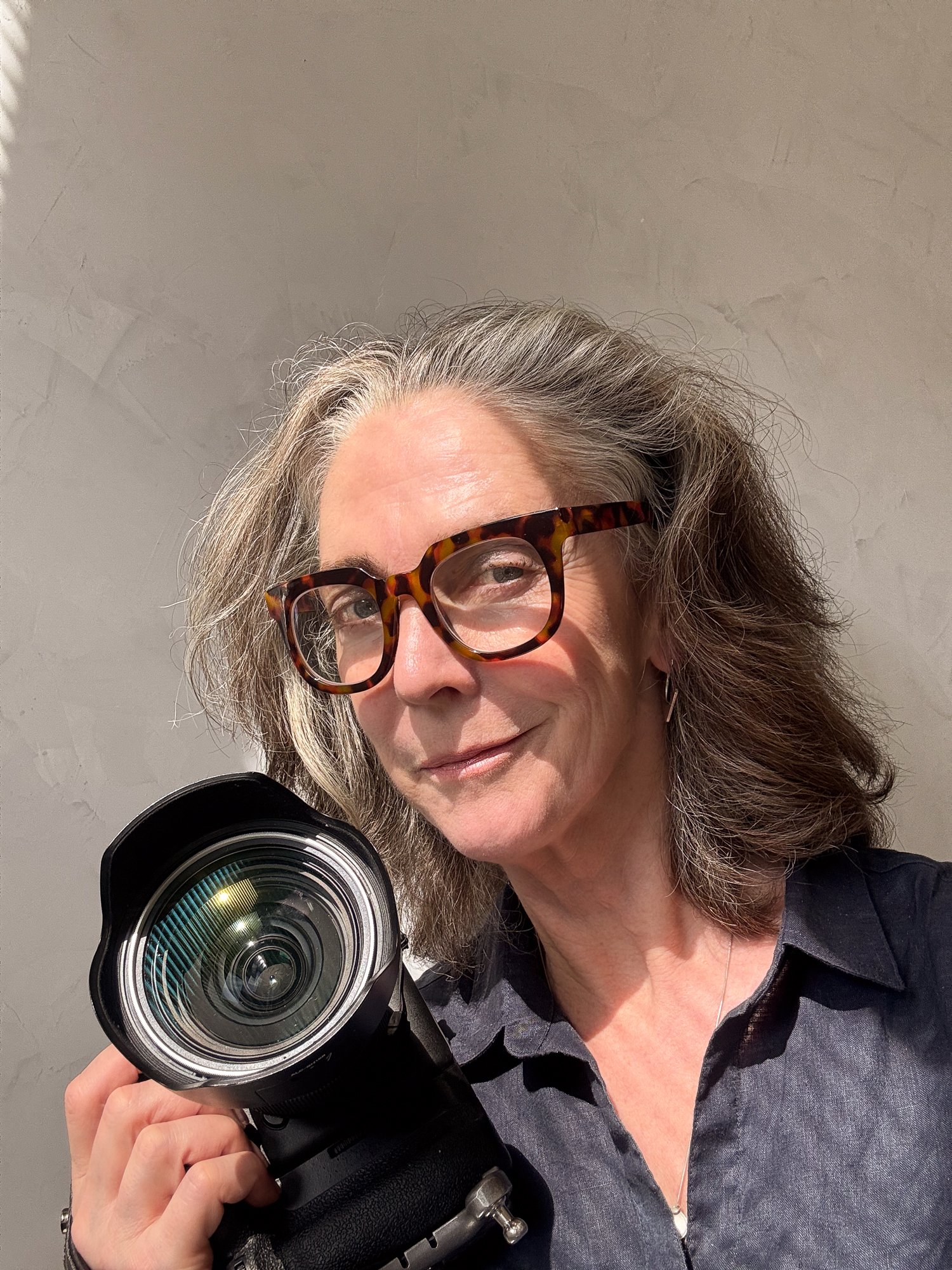 Photographer, Justine Cooper, taking a photo with a professional camera in her Brooklyn Photo Studio