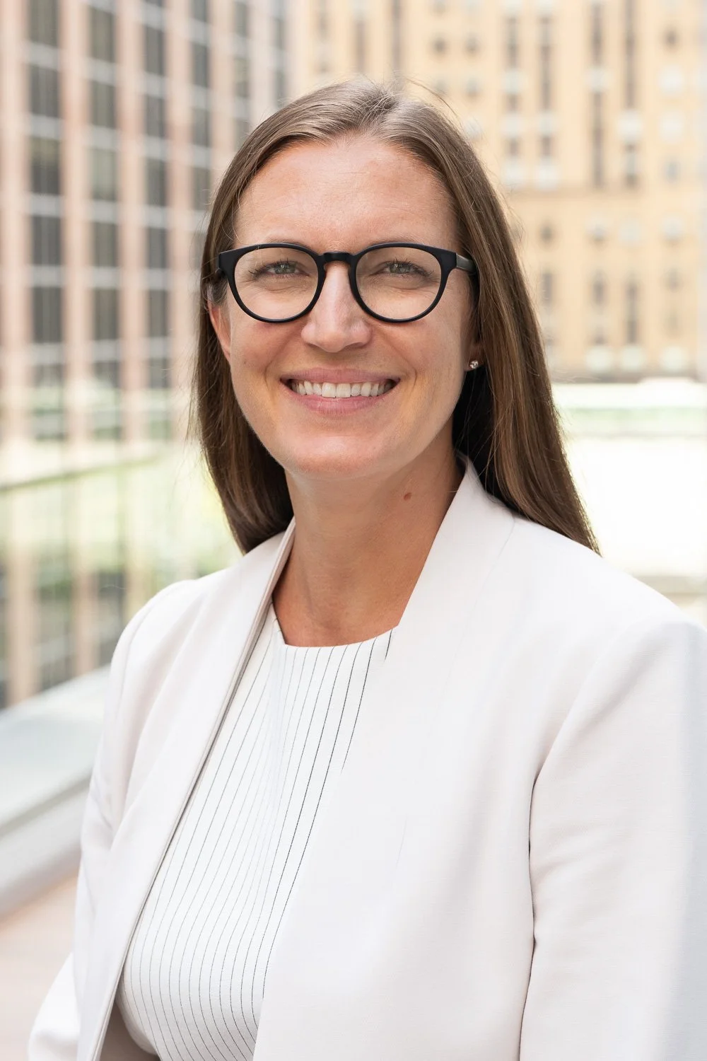 woman insurance executive in exterior headshot in midtown