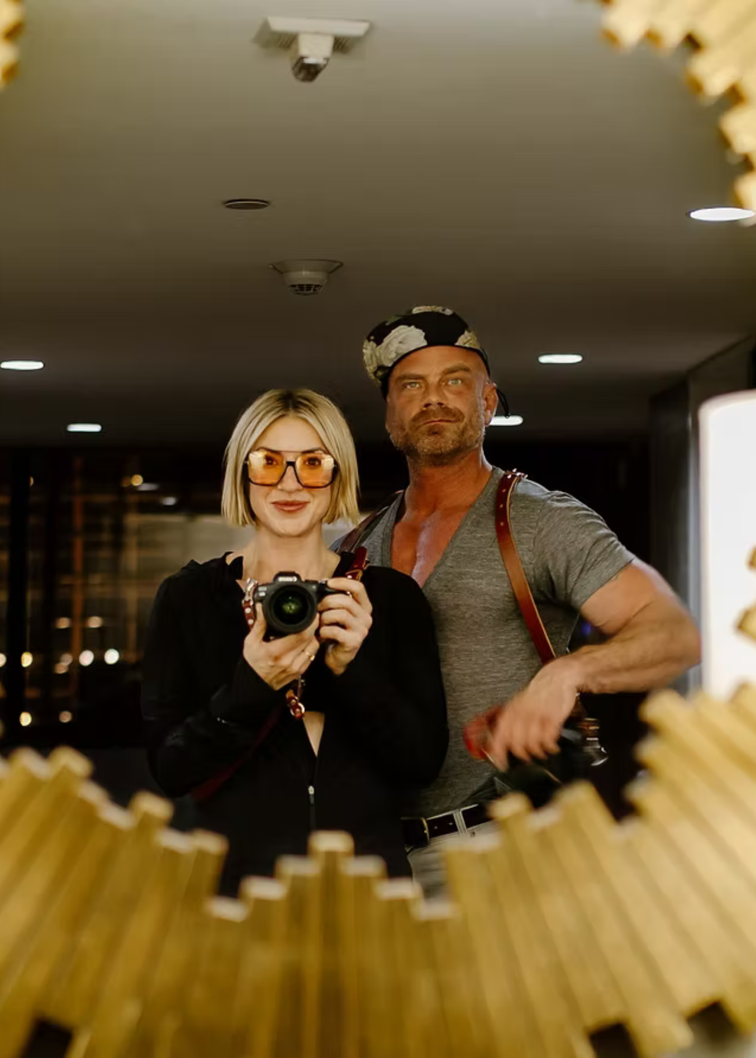 Creative mirror portrait of Aperture & Atlas photographers Stuart and Autumn framed by a decorative popcorn border.