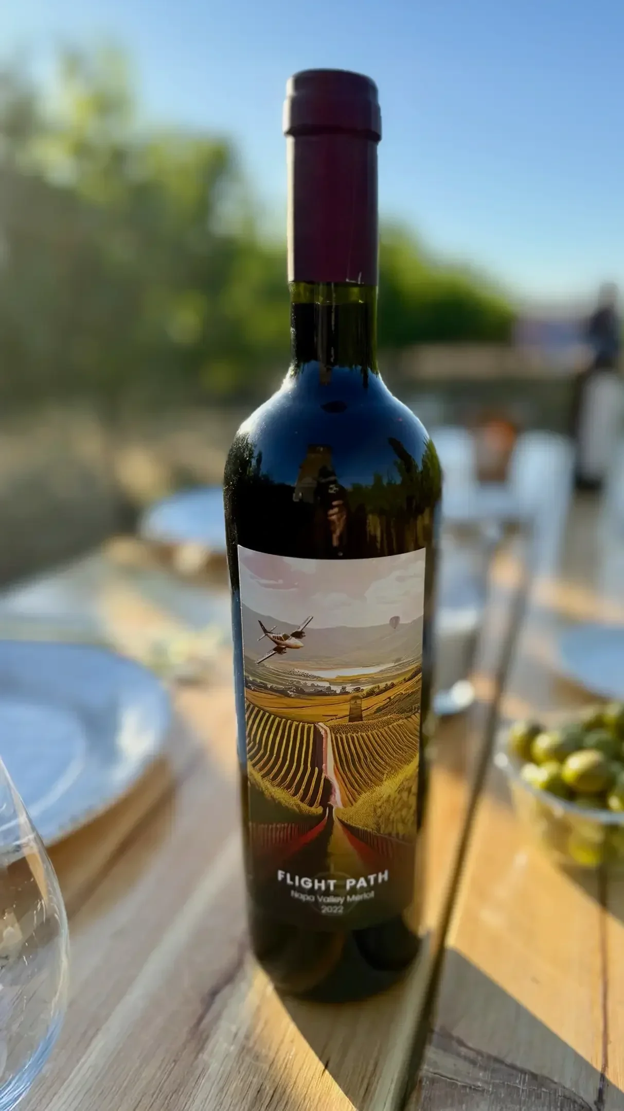 2022 Merlot on a set table in the Flight Path Vineyard