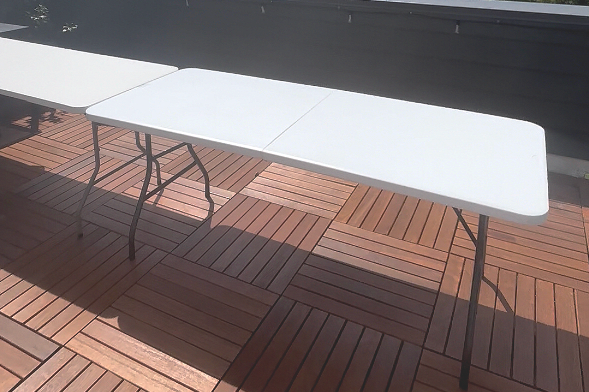 White rectangular table on a wooden deck.