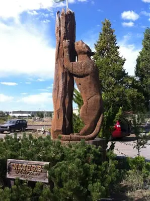 Nature (1996)  A cougar carving a tree with its claws,   carved from a single piece of cedar,  on display in front of the weed mercantile mall.