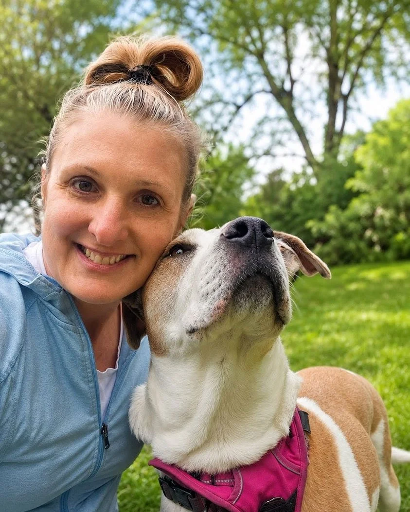 Woman pet caregiver with a large cute dog white and brown dog.