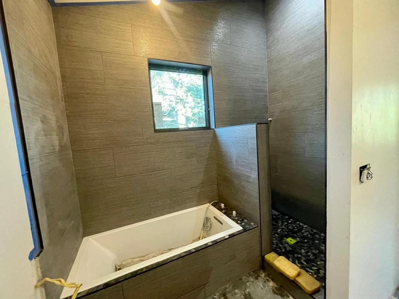 walk_in_shower_and_jet_tub_tile_installation.jpeg