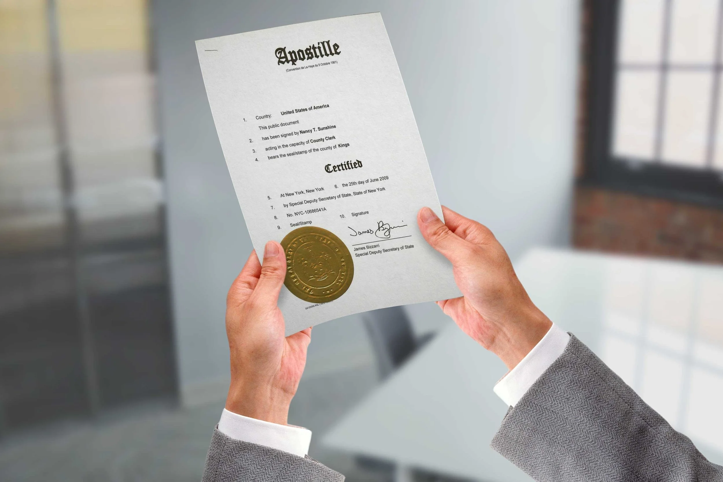Hands holding an apostilled document, representing apostille and legalization
