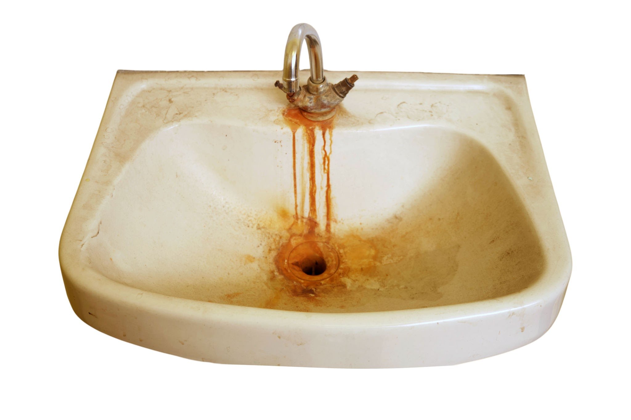 A dirty, stained bathroom sink with rusty water dripping from the faucet.