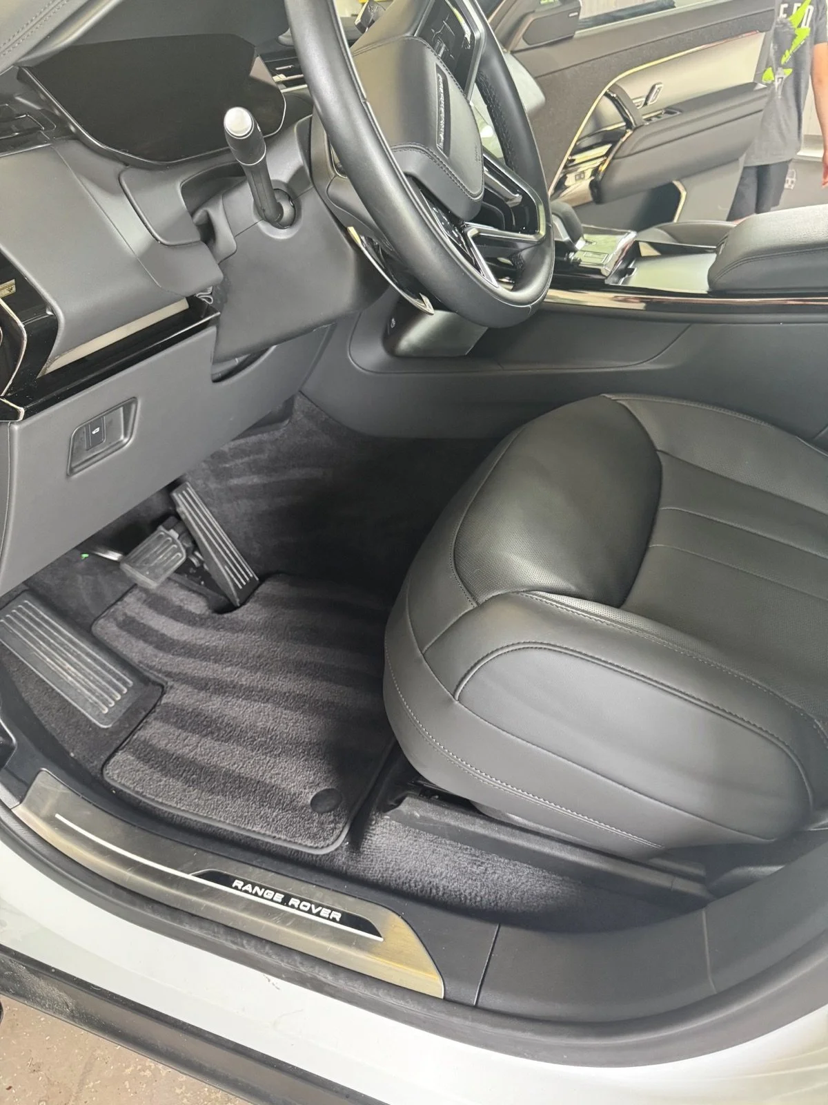 Freshly detailed Range Rover driver area with clean leather, trim and carpeting.