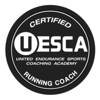 Black circular logo with white text that reads 'Certified USATF United Endurance Sports Coaching Academy Running Coach'.
