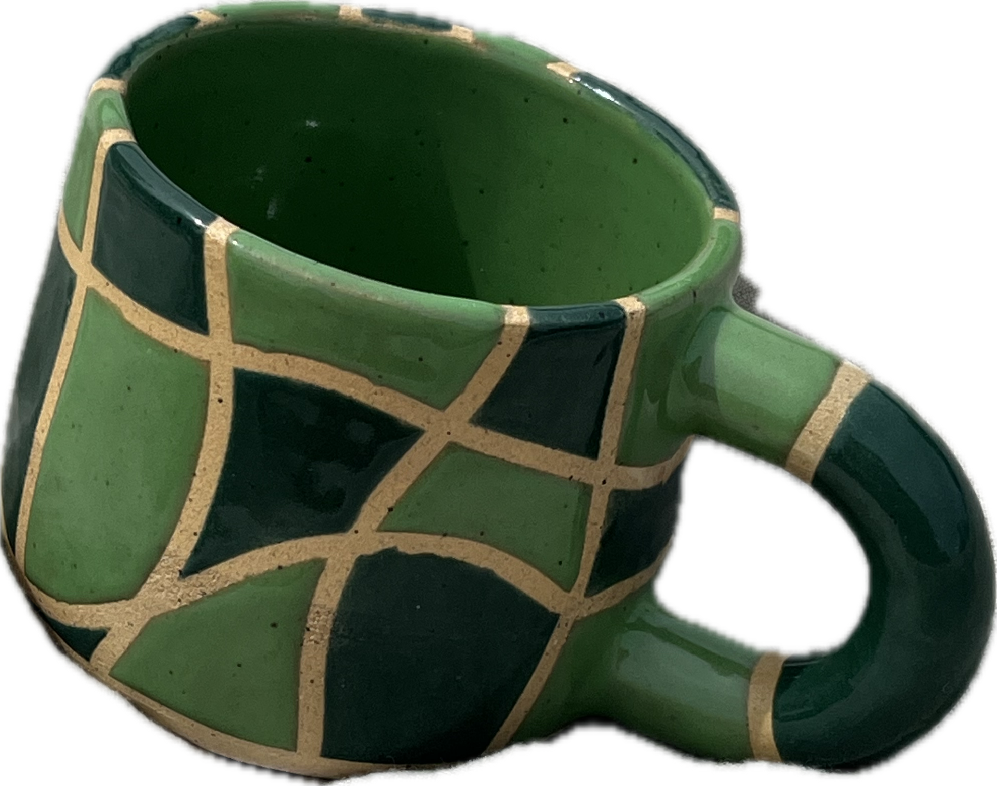 Green ceramic mug with black and gold geometric patterns.