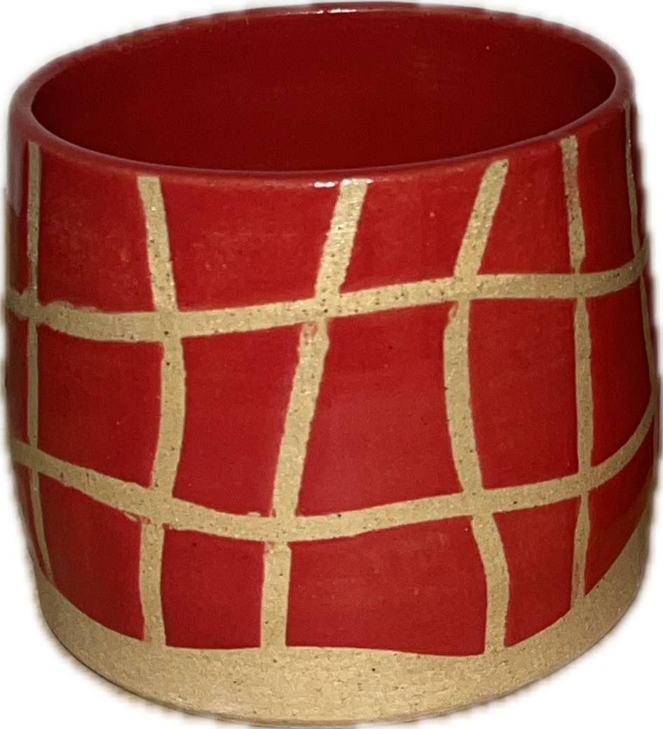 Red ceramic pot with a cream-colored geometric grid pattern