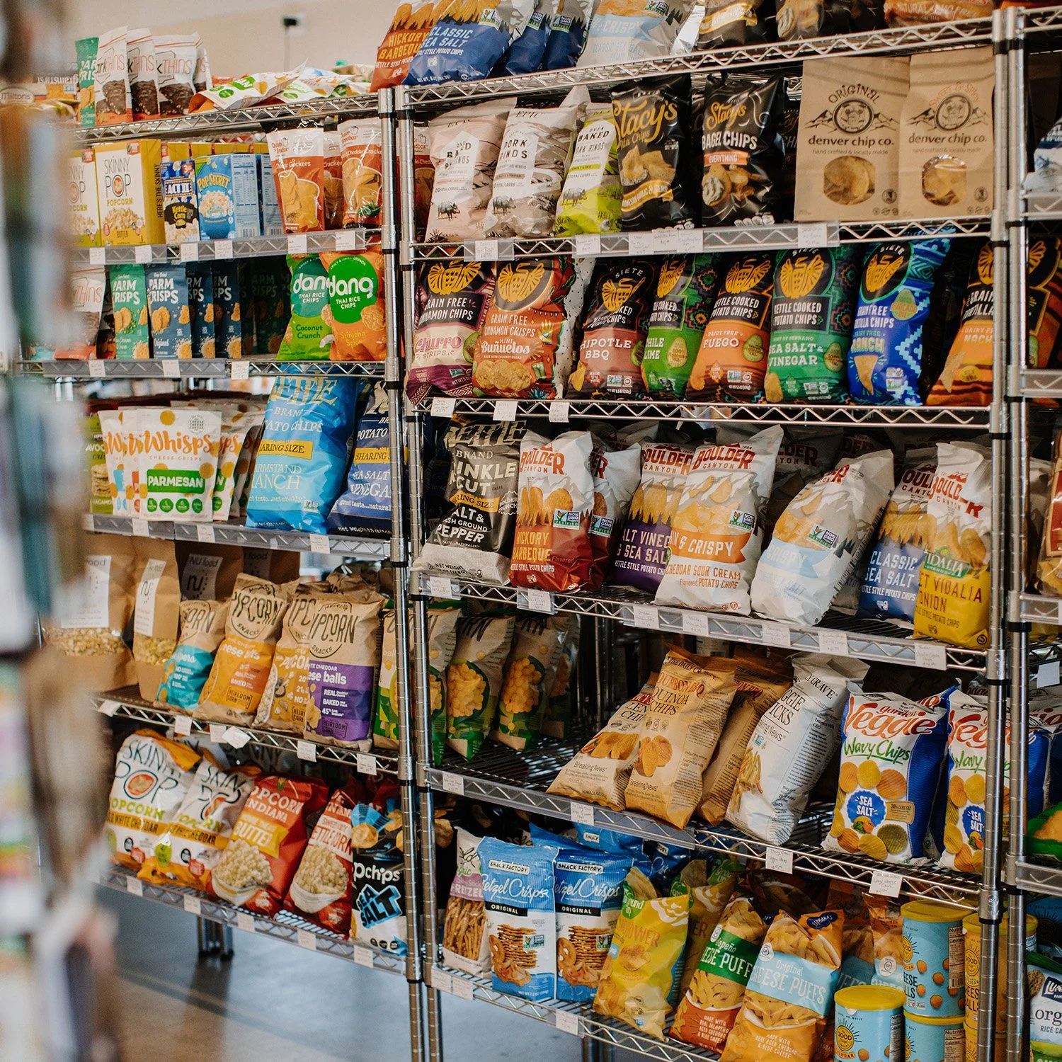 A variety of different snacks and chips on store shelves