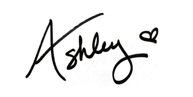 Autographed signature reading 'Ashley' with a small heart doodle