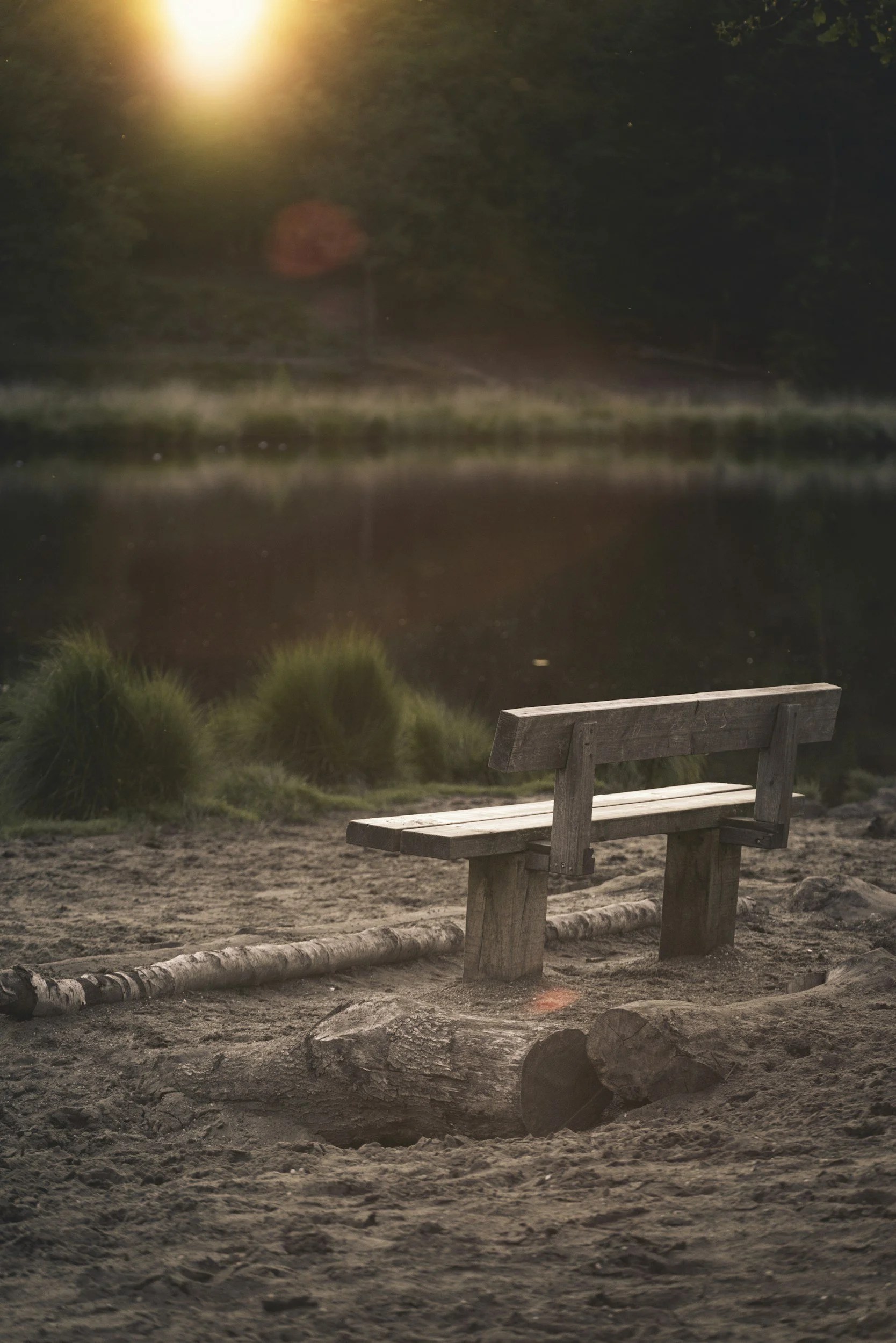 Image of a bench by the water representing how depression therapy can help clients cope with sadness, emotional exhaustion, loneliness, and burnout