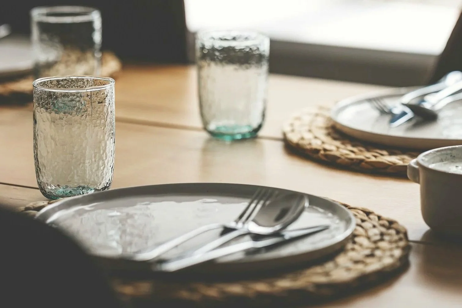 Warm dining table place setting representing eating disorder recovery, body image healing, and a healthier relationship with food through eating disorder therapy