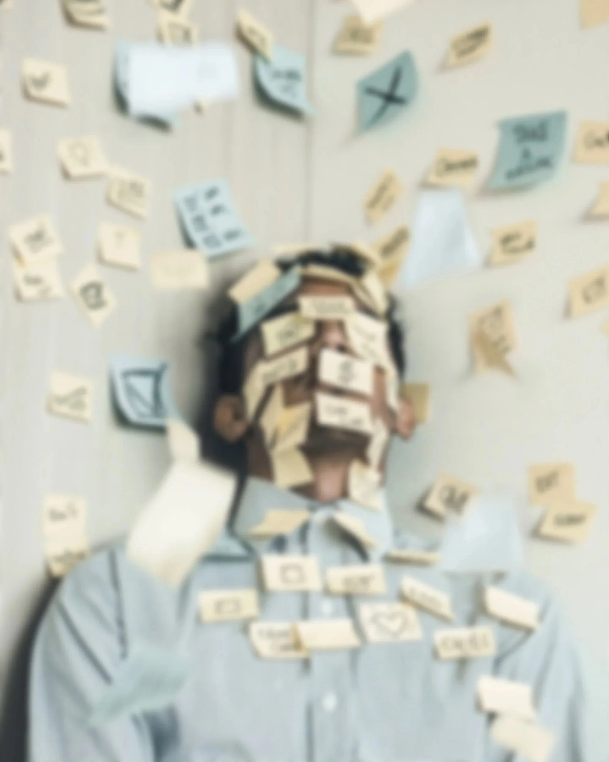 Image of man with sticky notes on him, representing the burnout, overwhelm, and stress that online anxiety therapy can help soothe