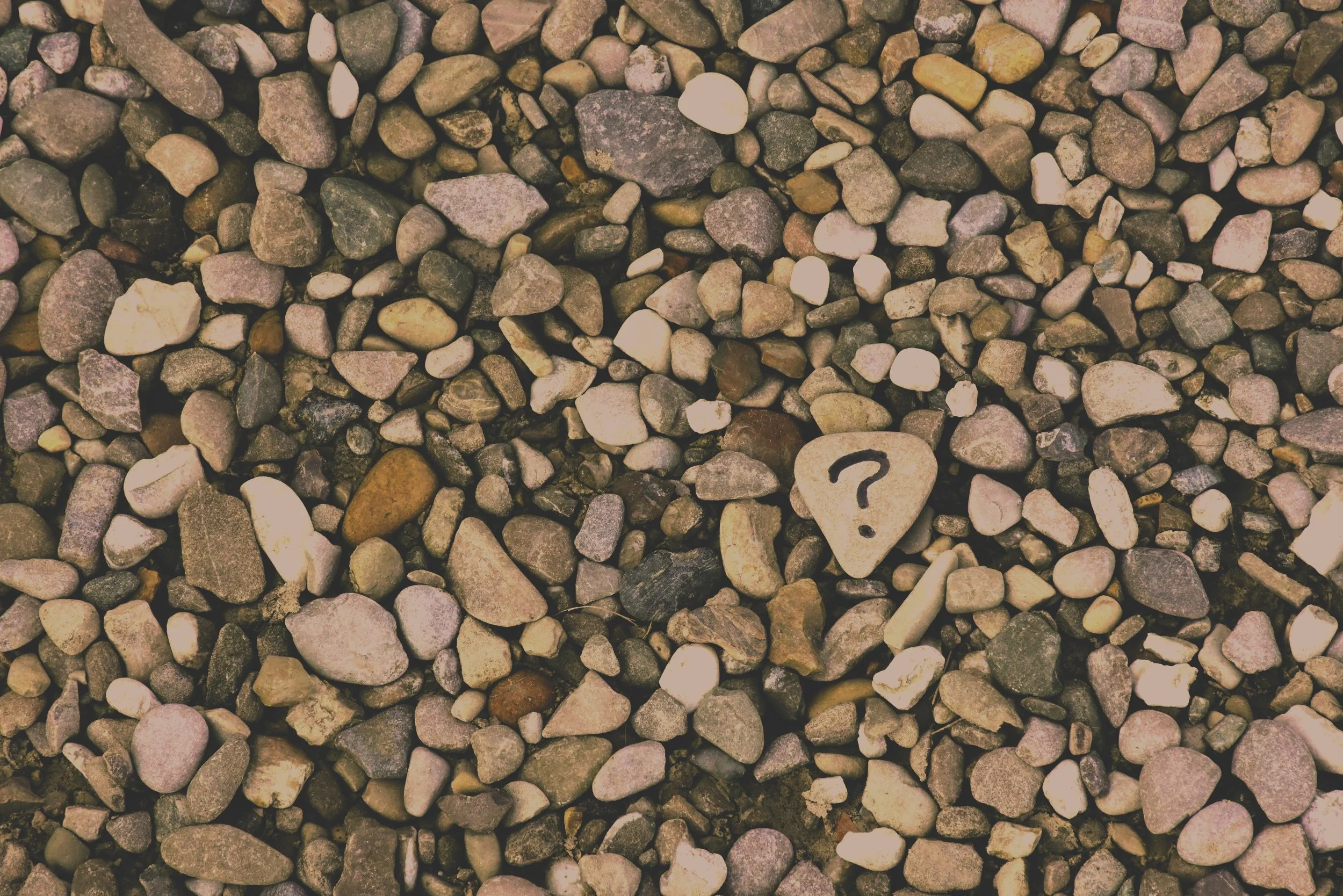 Image of rocks with a question mark symbolizing an anxiety therapist helping clients manage stress, anxious thoughts, and emotion regulation