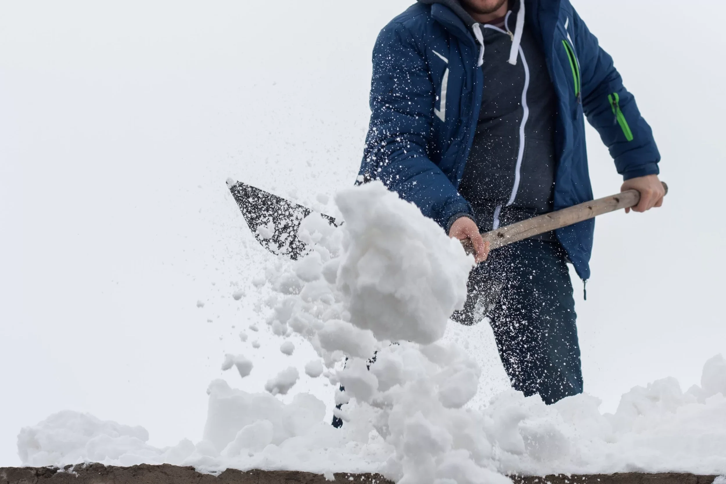 Canva-Young-man-clean-a-roof-from-snow-by-shovel.-Spring-snow-removing-after-blizzard.-1-1-scaled.webp