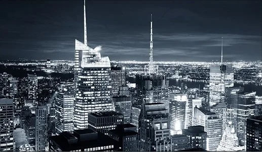 Blue-toned city skyline representing organizational infrastructure and advisory support