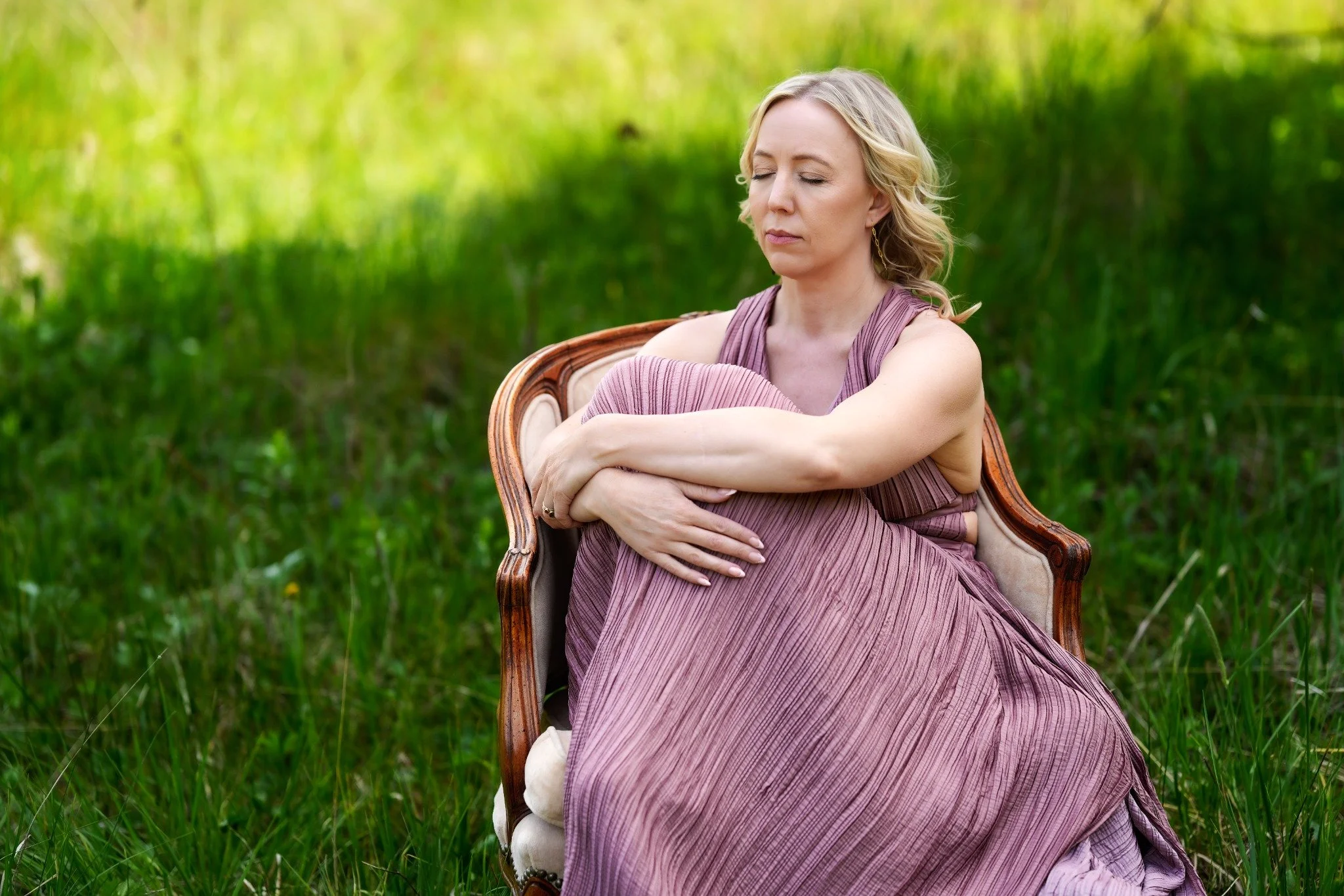 Karen Bommentre, LMFT, seated outdoors with eyes closed at Wild Gem Therapy in Ketchum, Idaho