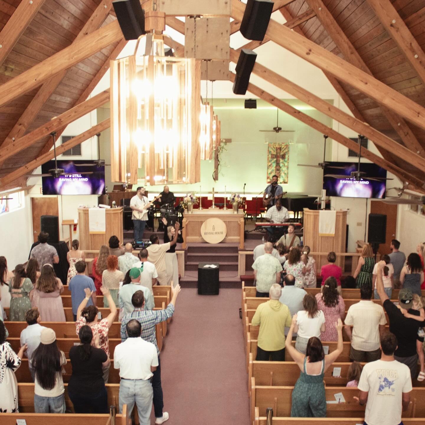 People worshipping in a sanctuary at Revival House