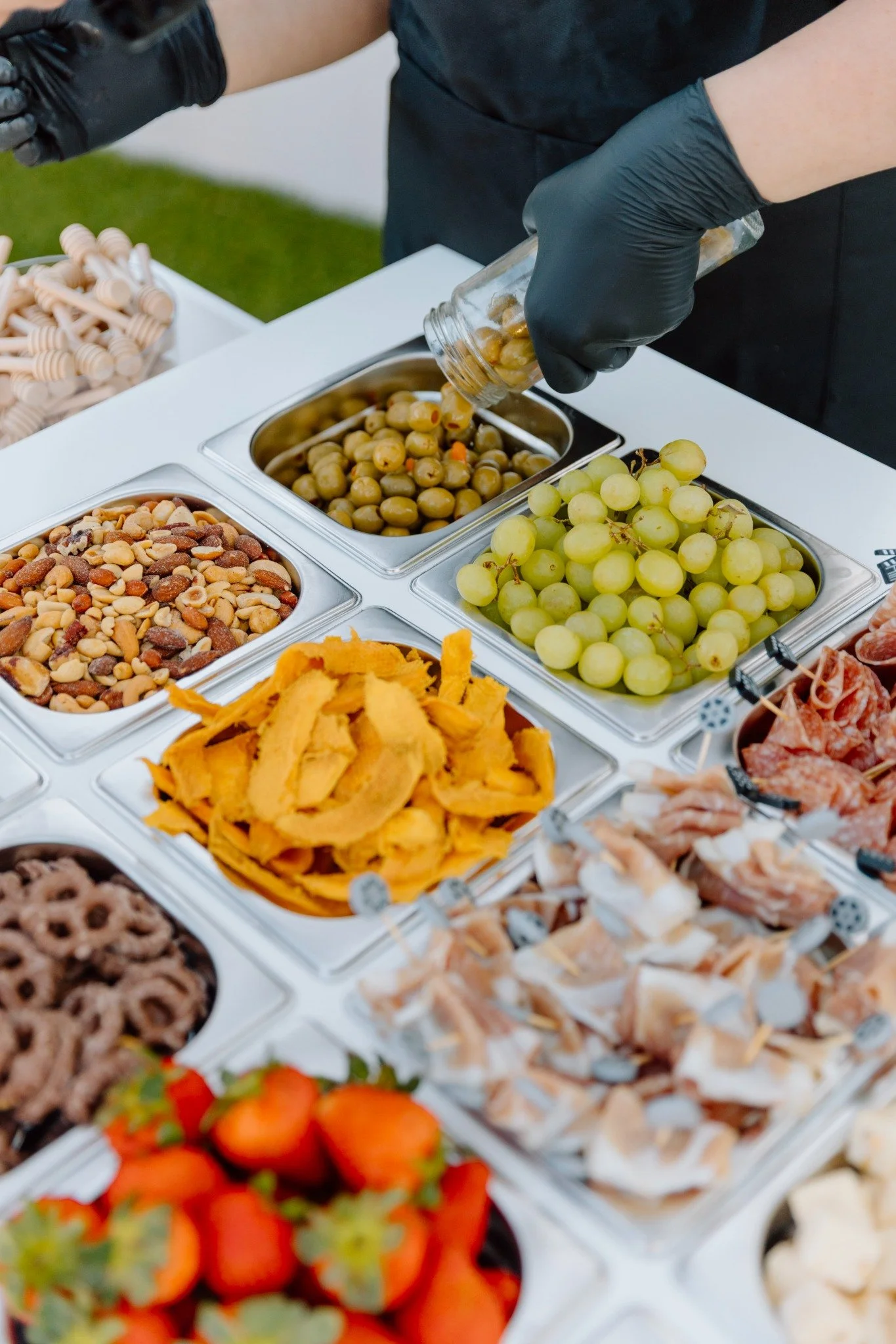 A Yes Please attendant arranging fresh charcuterie ingredients