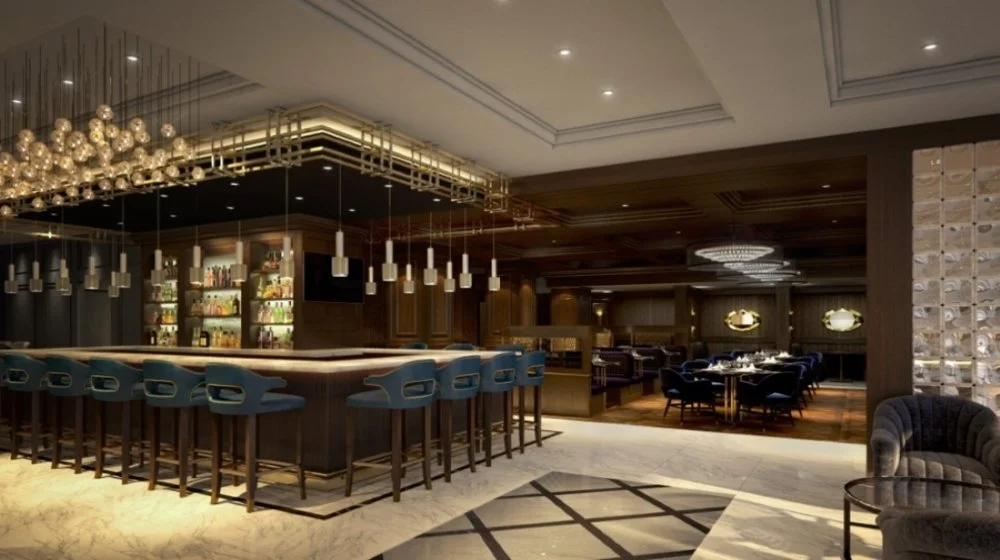 Luxurious hotel bar and dining area with modern decor, dark wood finishes, plush seating, and stylish lighting fixtures.