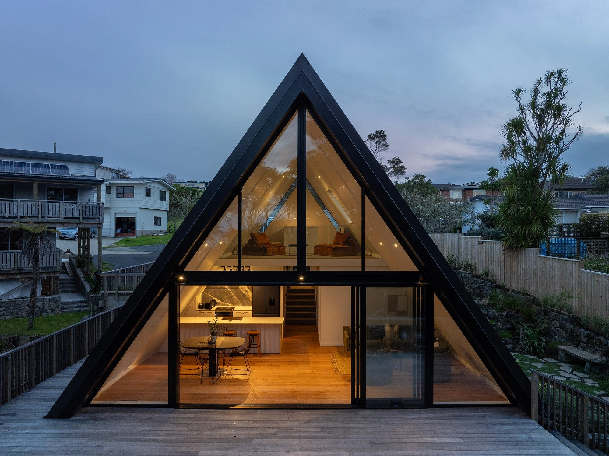 Interior view of a new build A-frame house in Auckland at dusk.
