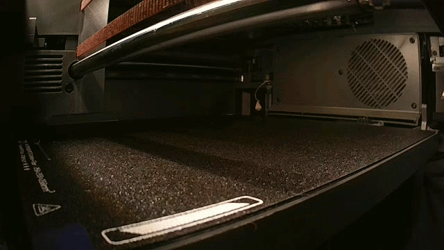 Time lapse of a 3D printer showing the print bed printing gray tract holders.