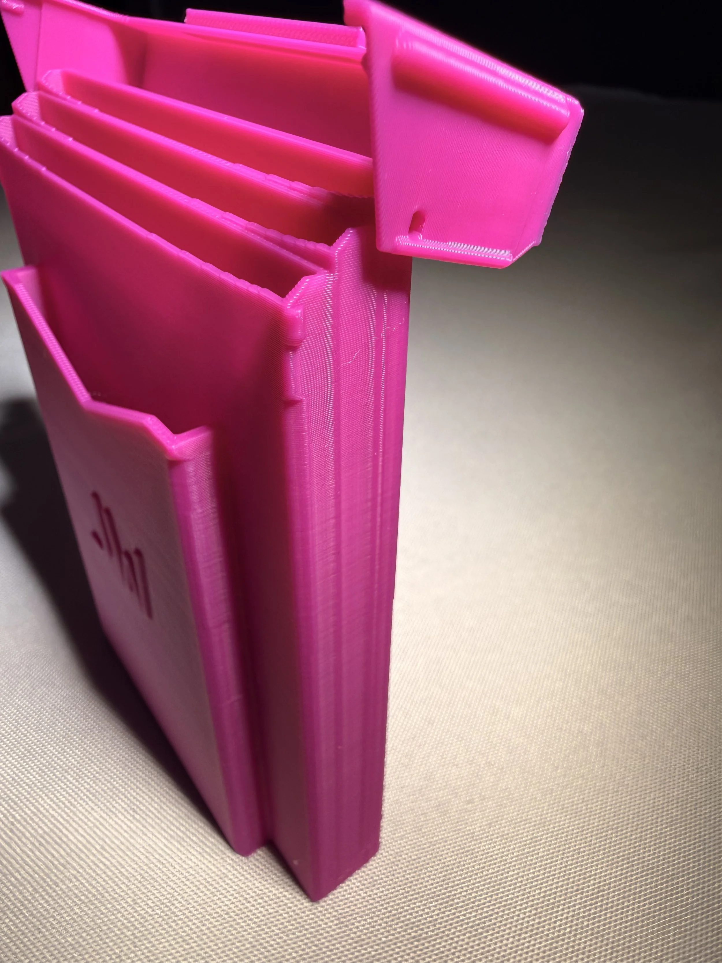 Pink tract holder with reinforced lid.