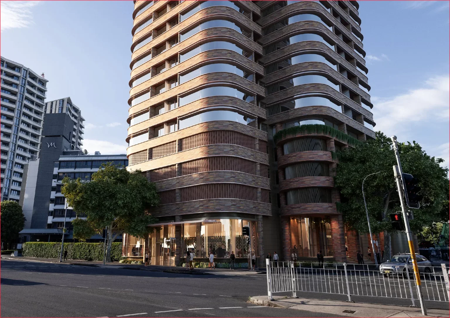 Modern multi-story building with rounded architecture, glass windows, and a brick exterior, situated on a city street with pedestrians, trees, and traffic signals.