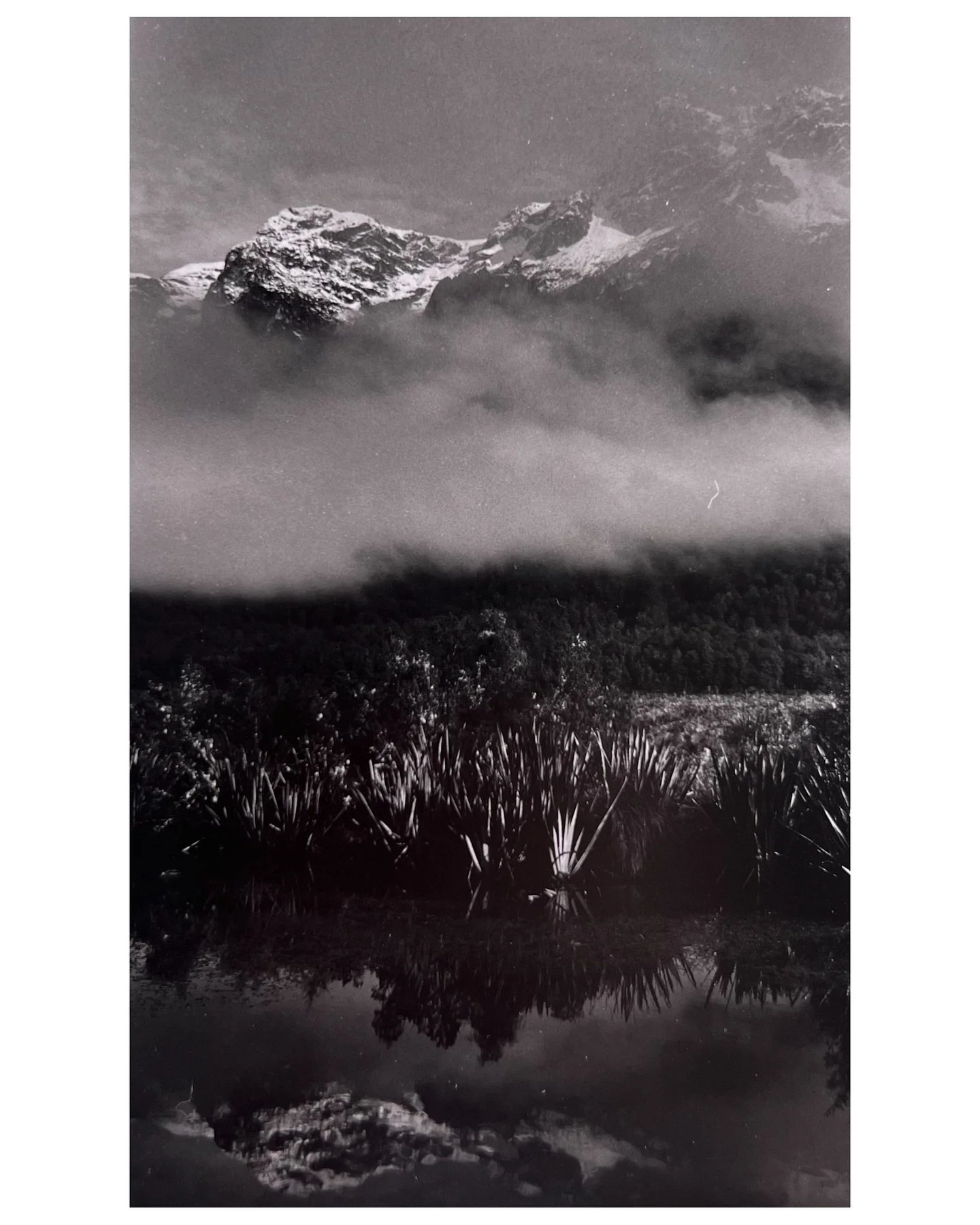 A very experimental image: Taken on my way to Milford Sound / Piopiotahi in Fiordland. On this day the weather was so permitting, allowing me to capture a beautiful reflection of the landscape on the water and a gorgeous haze in the middle ground of 