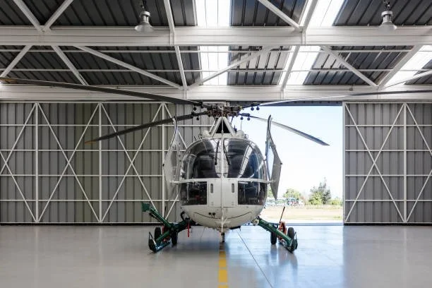 Helicopter inside an aircraft hangar before professional exterior detailing and polishing.