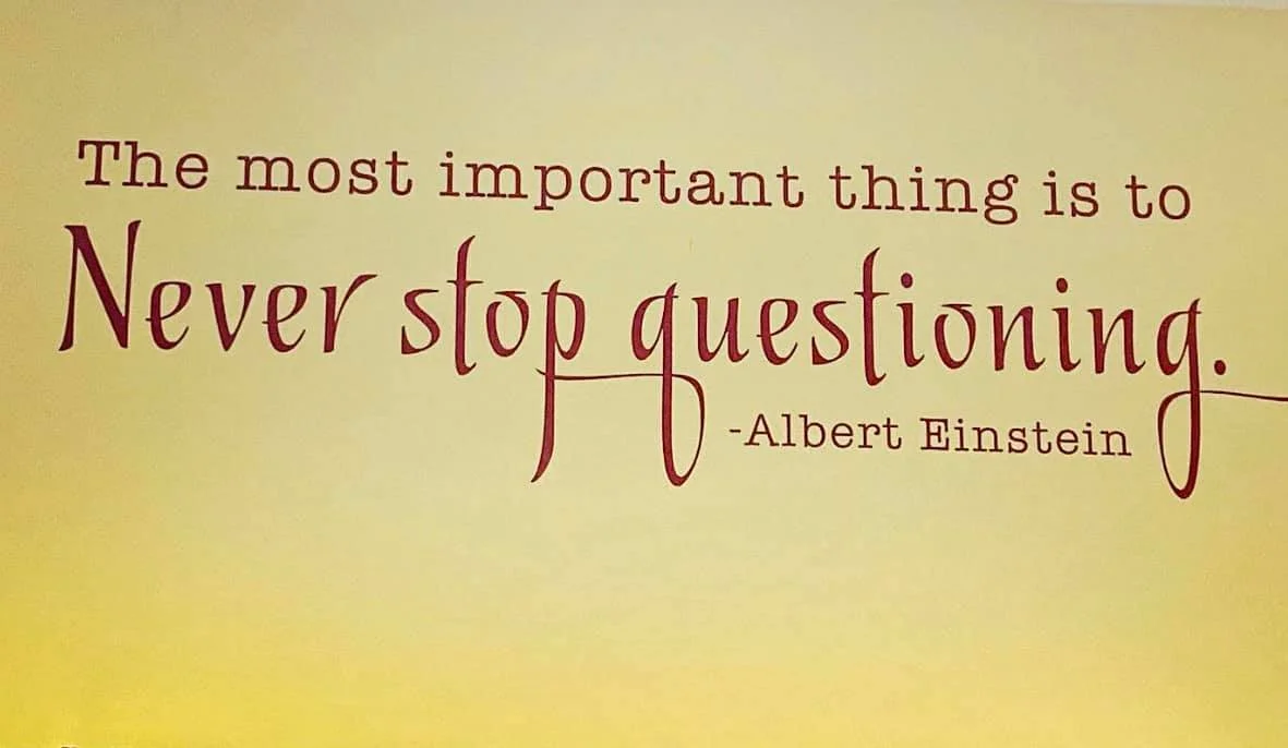 A motivational quote on a yellow background that says, "The most important thing is to Never stop questioning." attributed to Albert Einstein.