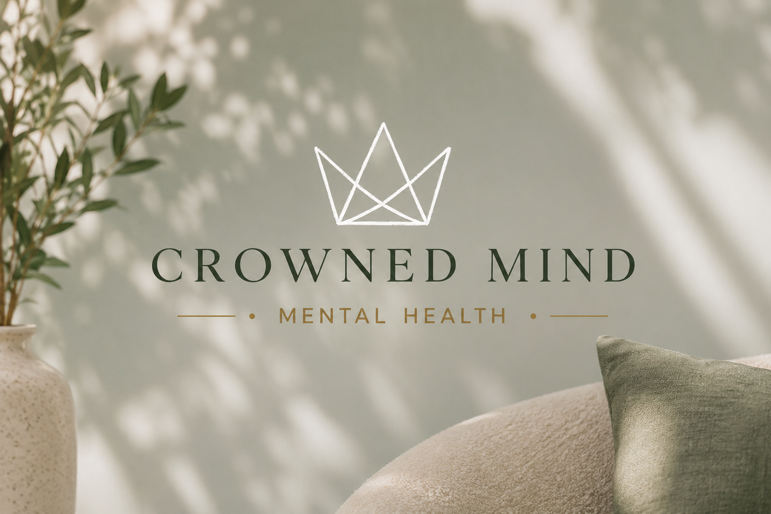 Logo for Crowned Mind Mental Health with a crown outline, next to a beige sofa with green pillow, and a potted plant in the background.
