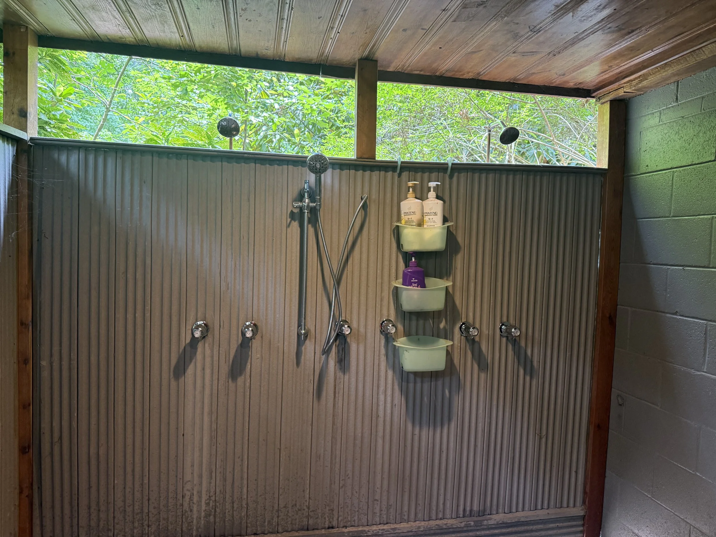 An outdoor shower with multiple showerheads