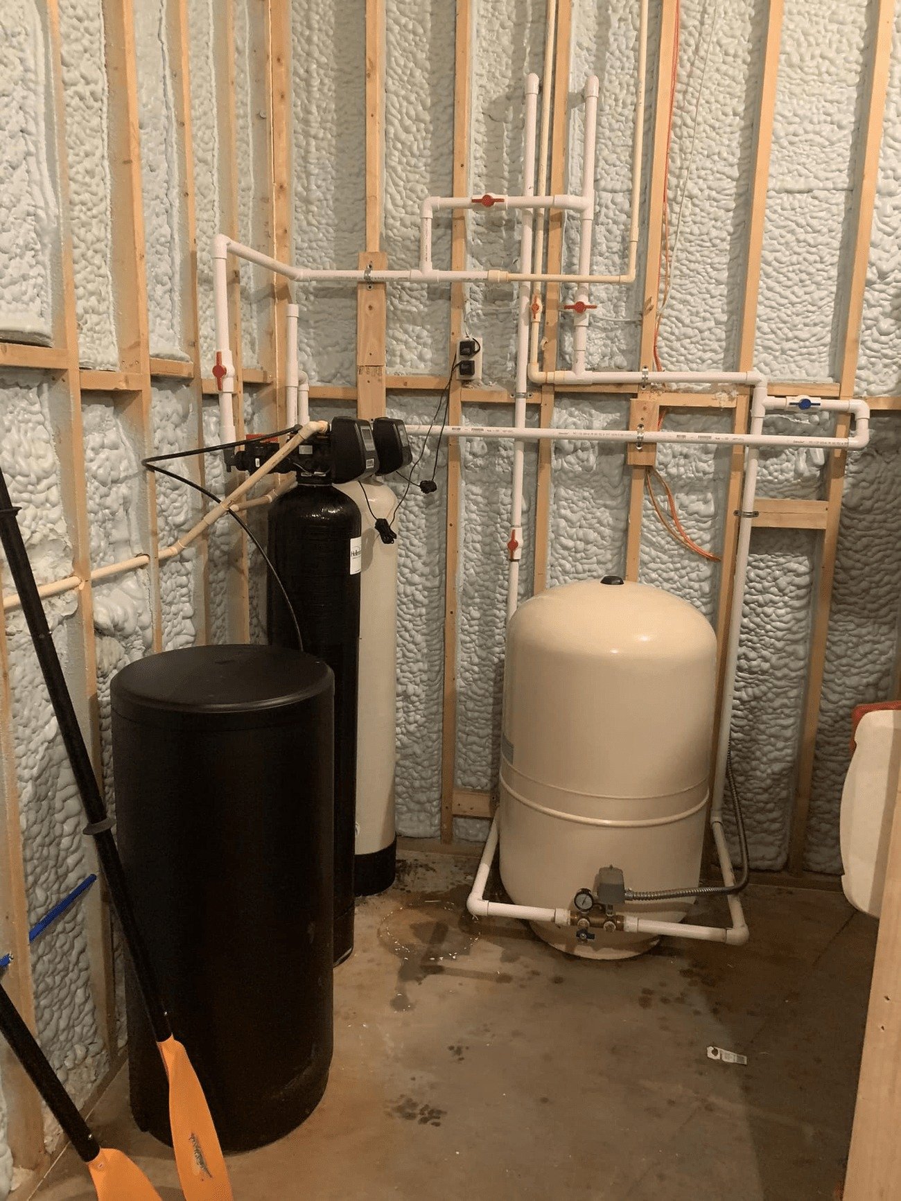 plumbing equipment, including a water softener system, a water filter, and a pressure tank.