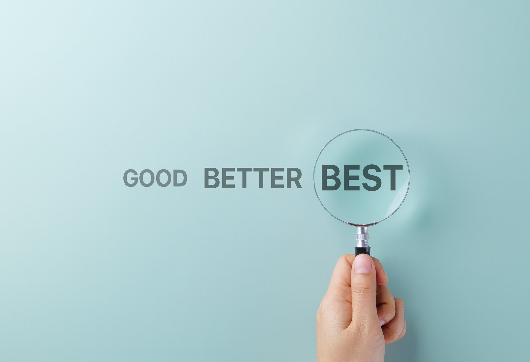 A magnifying glass over the words good, better, and best to compare medicare insurance options.