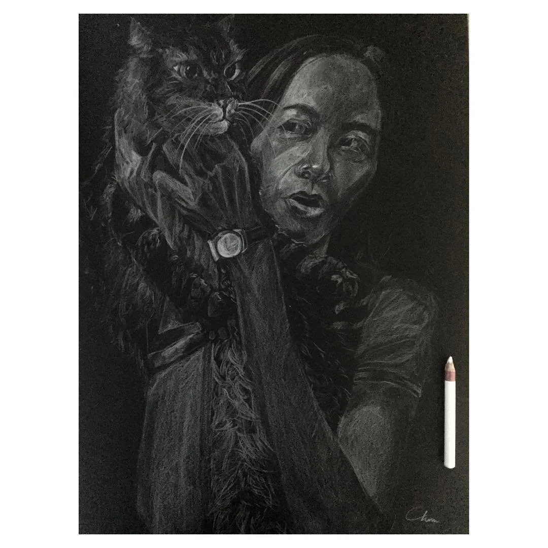 A detailed black-and-white chalk drawing of a woman holding a cat on her shoulder, with the cat wearing a collar and the woman wearing a watch.