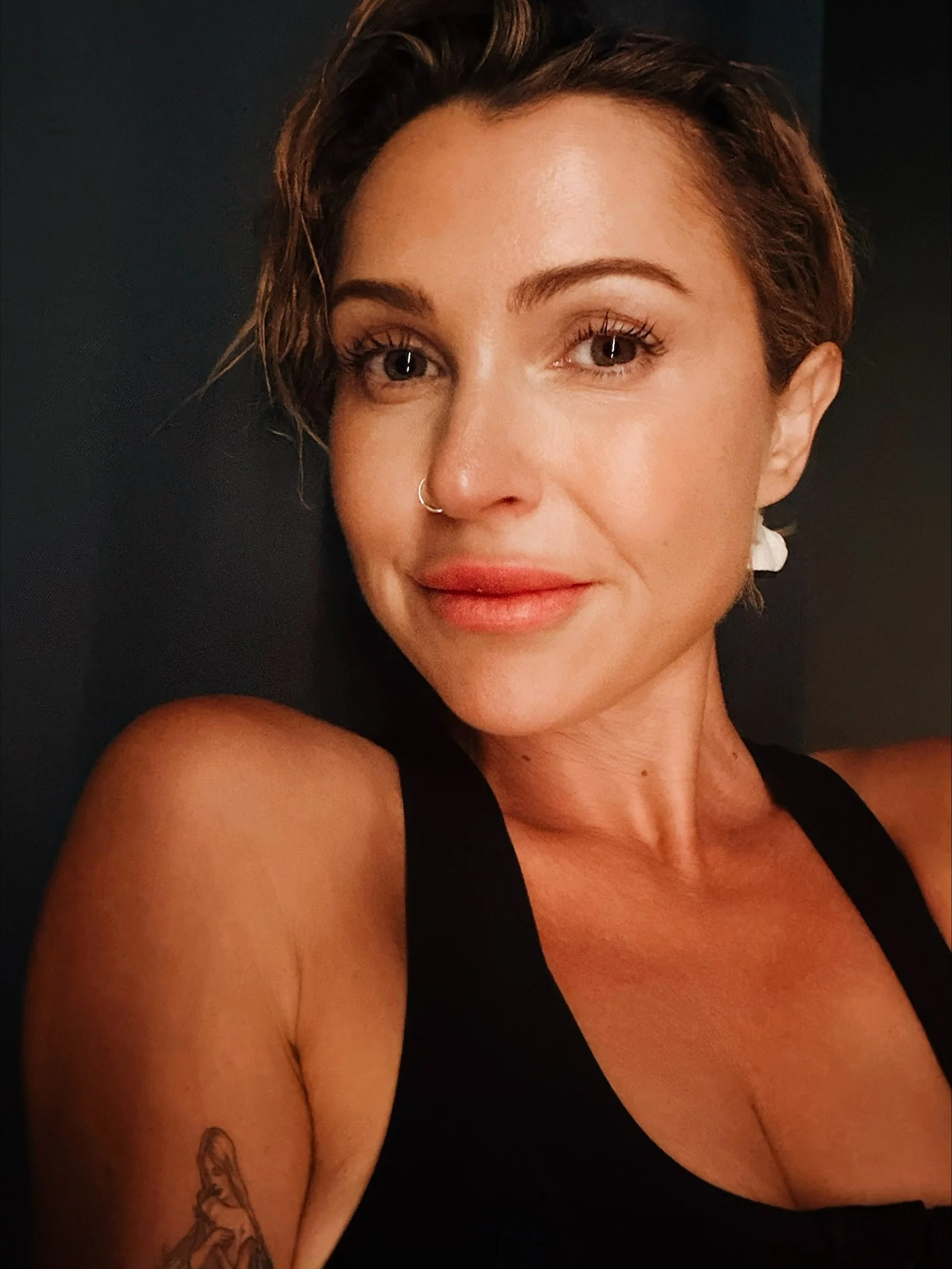 Rennie, founder of High Net Woman, in a warmly lit close-up portrait.