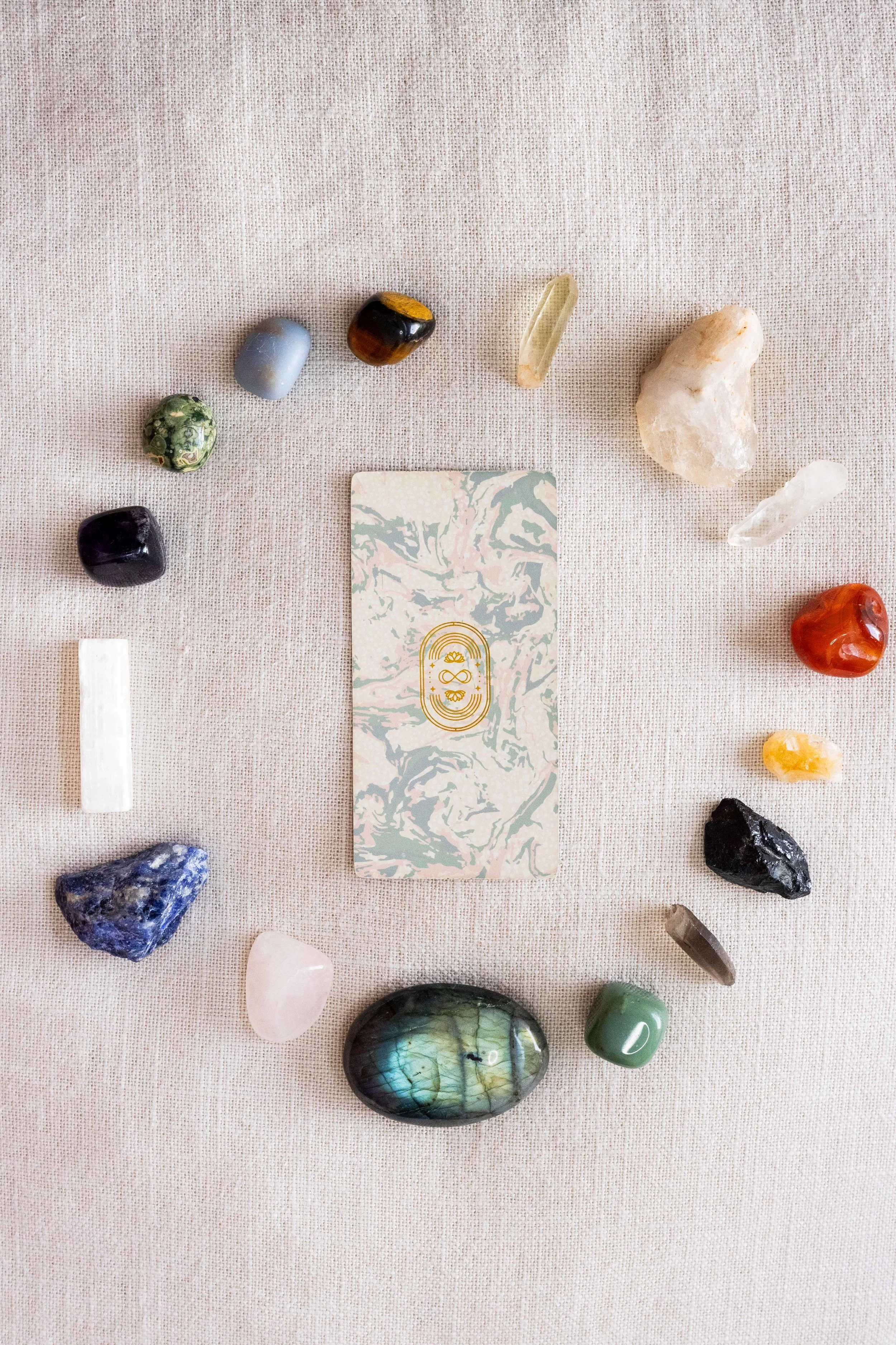 A circle of crystals surrounding a single tarot card.